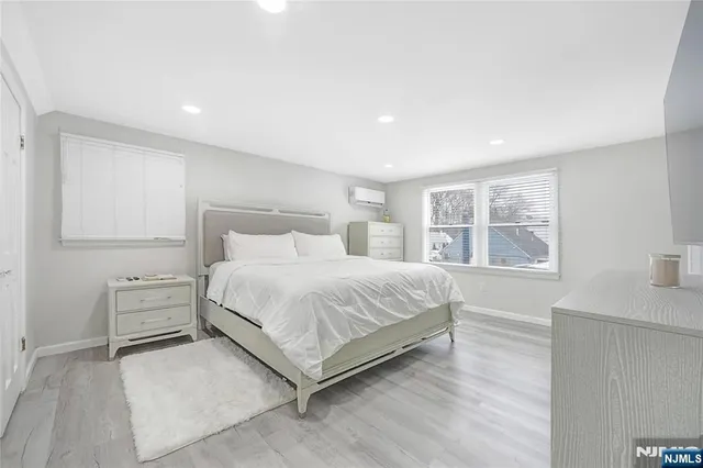 a spacious bedroom with a bed and a cabinets