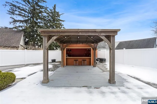 a view of a white house with a yard covered in snow