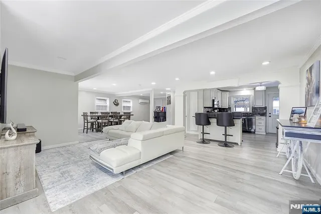 a living room with furniture and a dining table with kitchen view