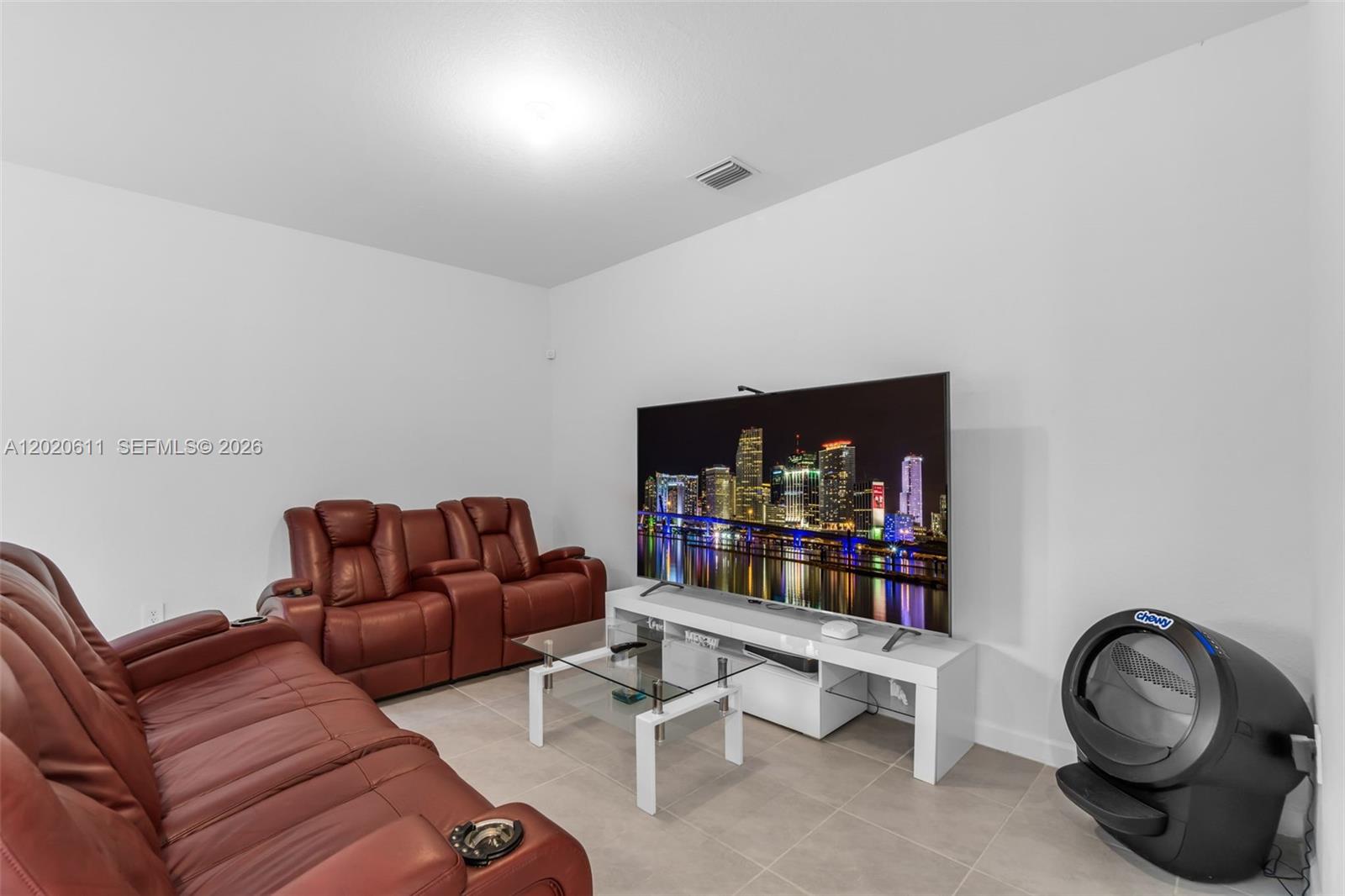 26455 Southwest 148th Avenue Homestead, FL 33032 - Photo 10 of 35 a living room with furniture a flat screen tv and a fireplace