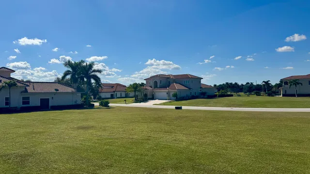 a view of a house with a swimming pool and a yard