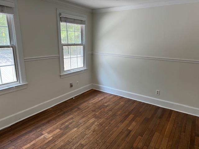 1409 Roper Road Bolivar, TN 38008 - Photo 19 of 33 Empty room with a wealth of natural light, ornamental molding, and dark hardwood / wood-style floors
