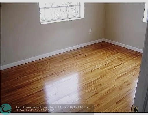 236 East 56th Street Hialeah, FL 33013 - Photo 6 of 7 a view of empty room with wooden floor