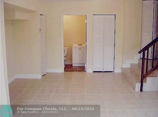236 East 56th Street Hialeah, FL 33013 - Photo 7 of 7 a view of an empty room with stairs