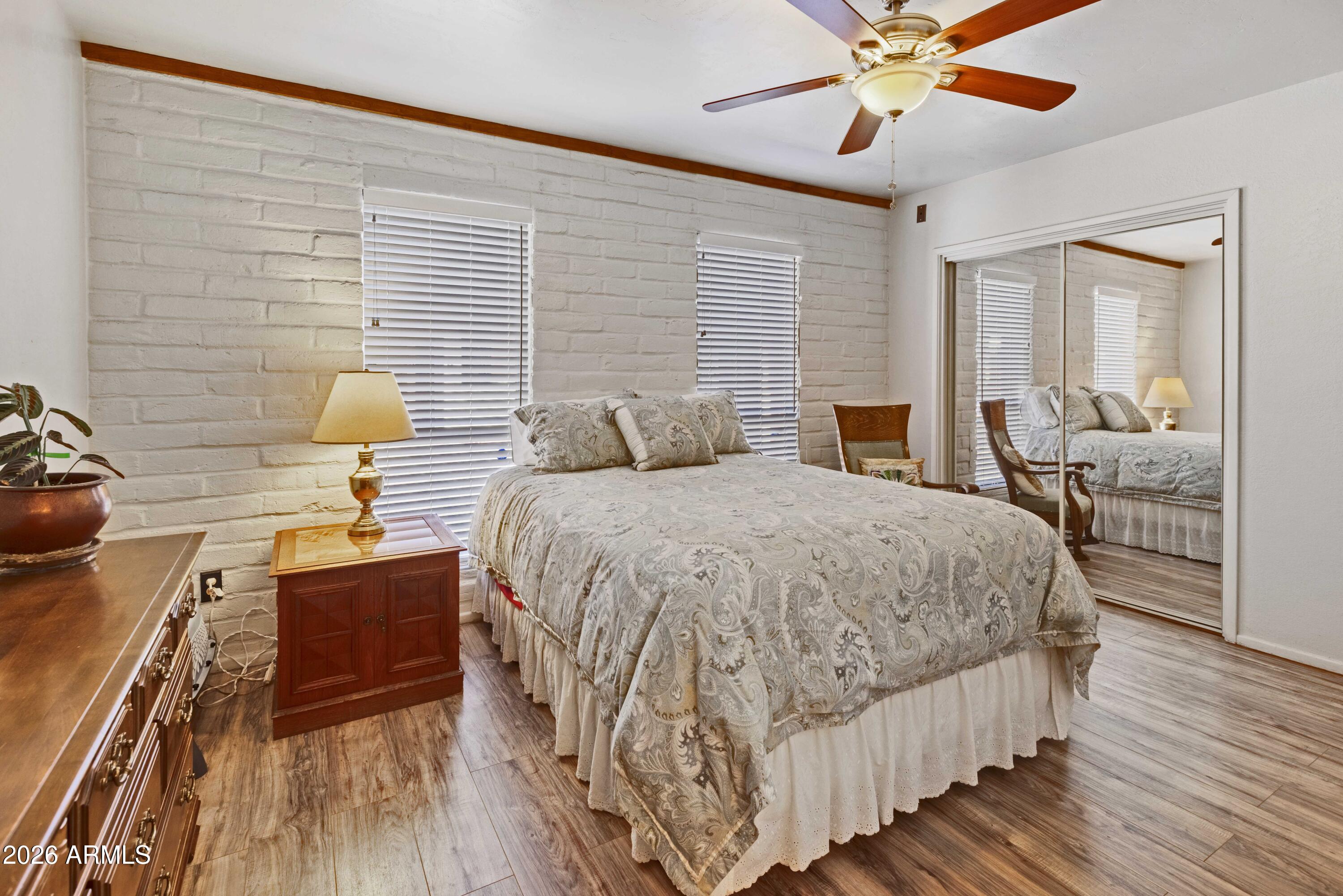 9111 North Oracle Road, Unit 110 Tucson, AZ 85704 - Photo 11 of 27 a bedroom with a bed and wooden floor