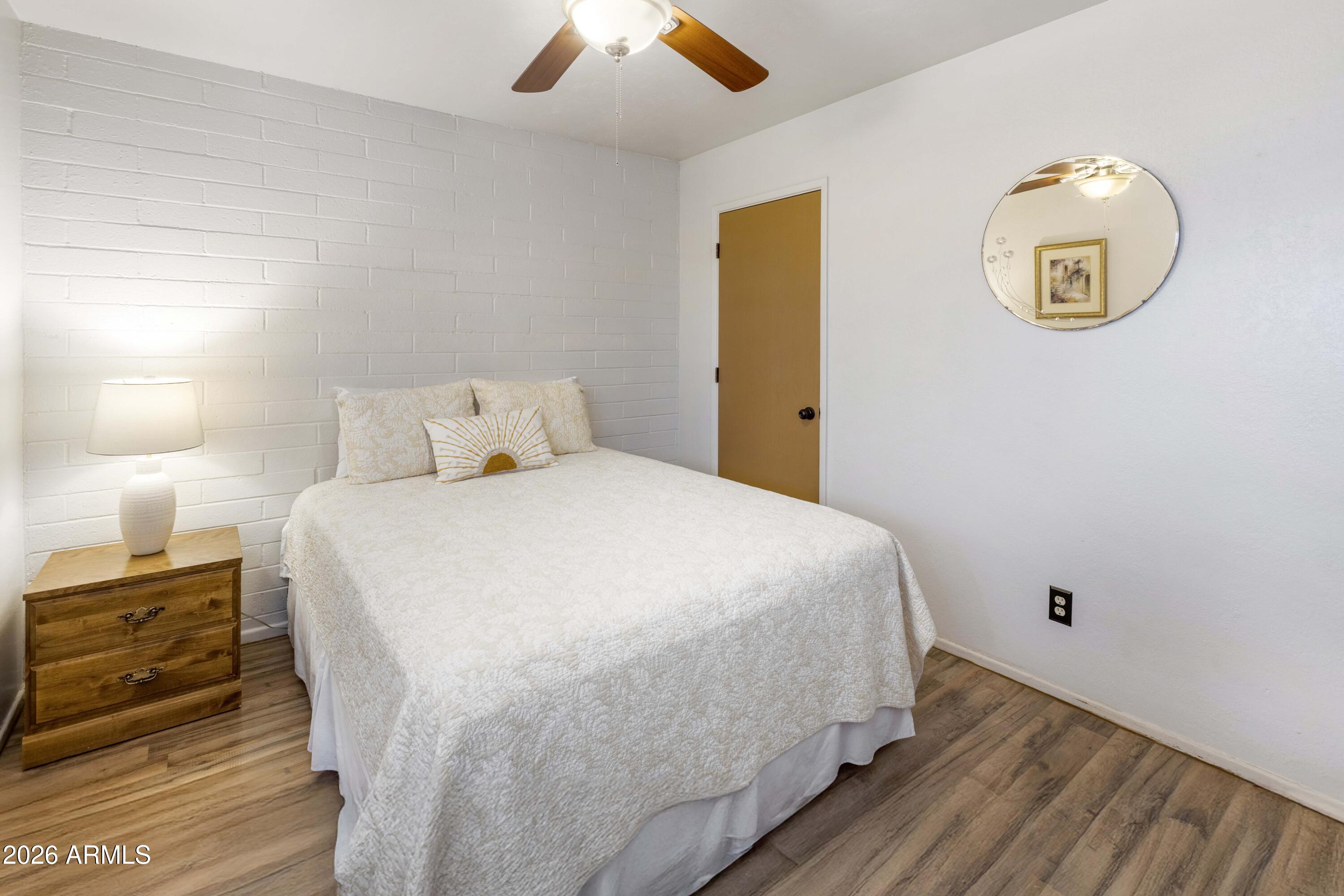 9111 North Oracle Road, Unit 110 Tucson, AZ 85704 - Photo 15 of 27 a bedroom with a bed and a chandelier