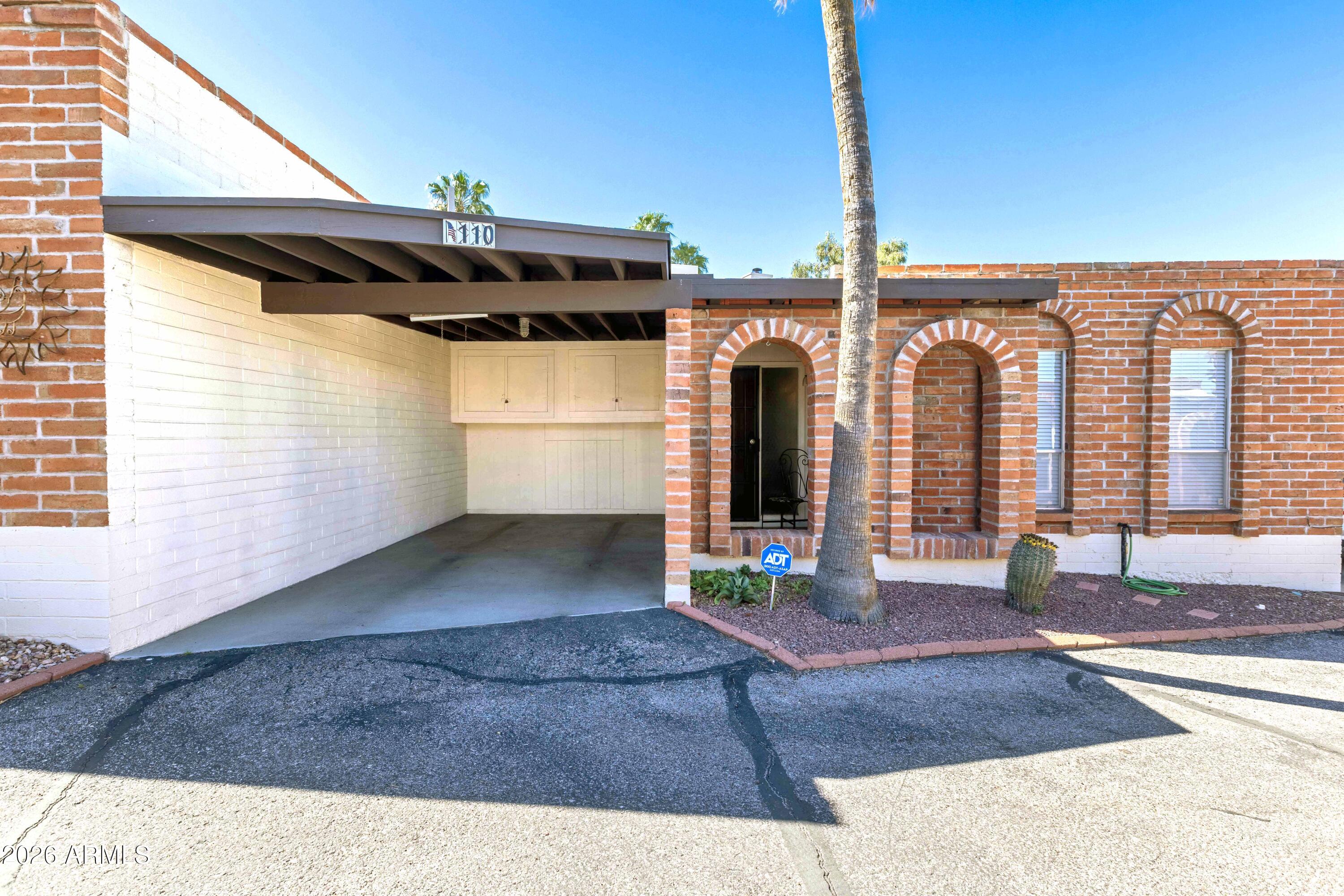 9111 North Oracle Road, Unit 110 Tucson, AZ 85704 - Photo 20 of 27 a front view of a house with a yard and garage