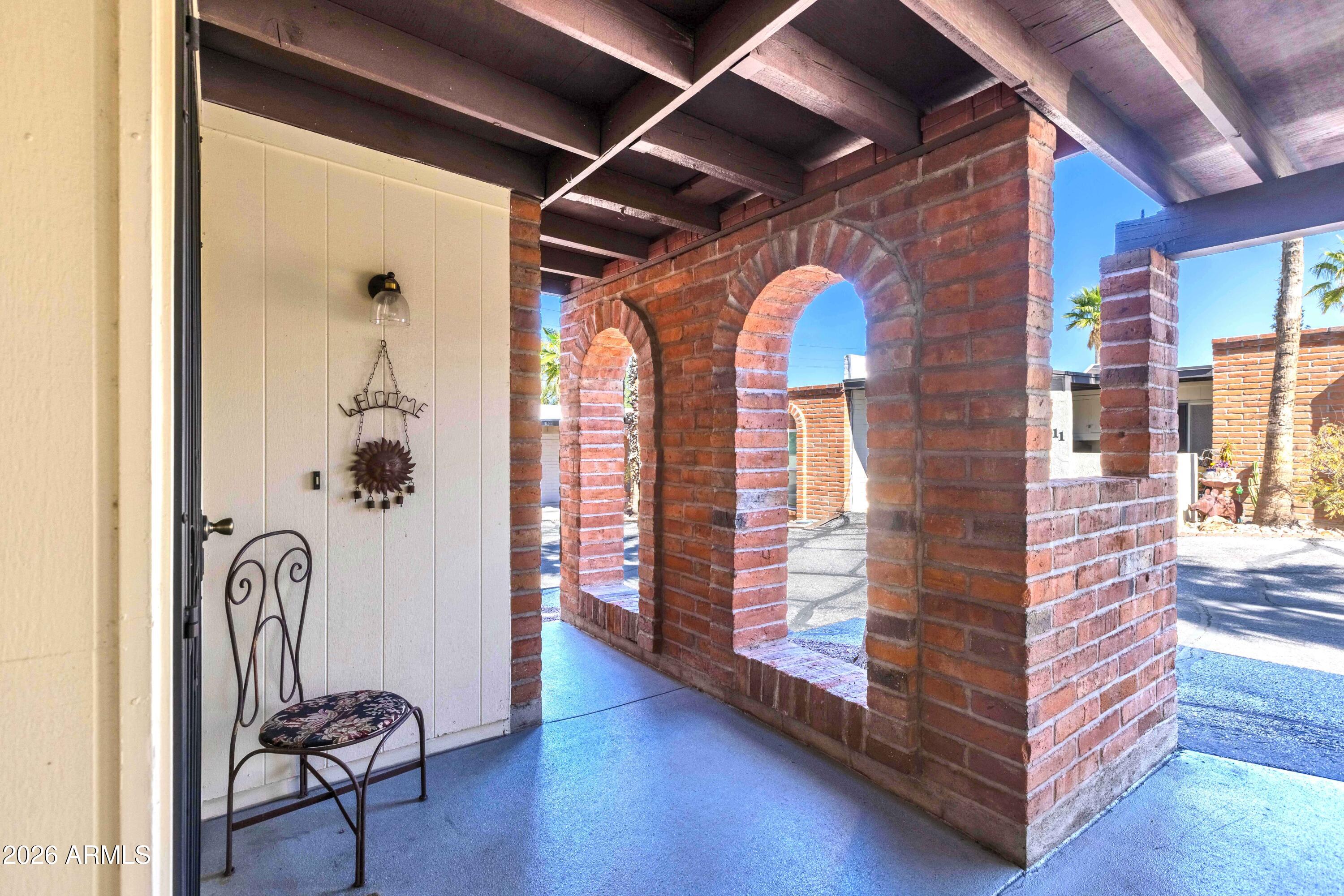 9111 North Oracle Road, Unit 110 Tucson, AZ 85704 - Photo 2 of 27 a view of an entryway with wooden floor and windows