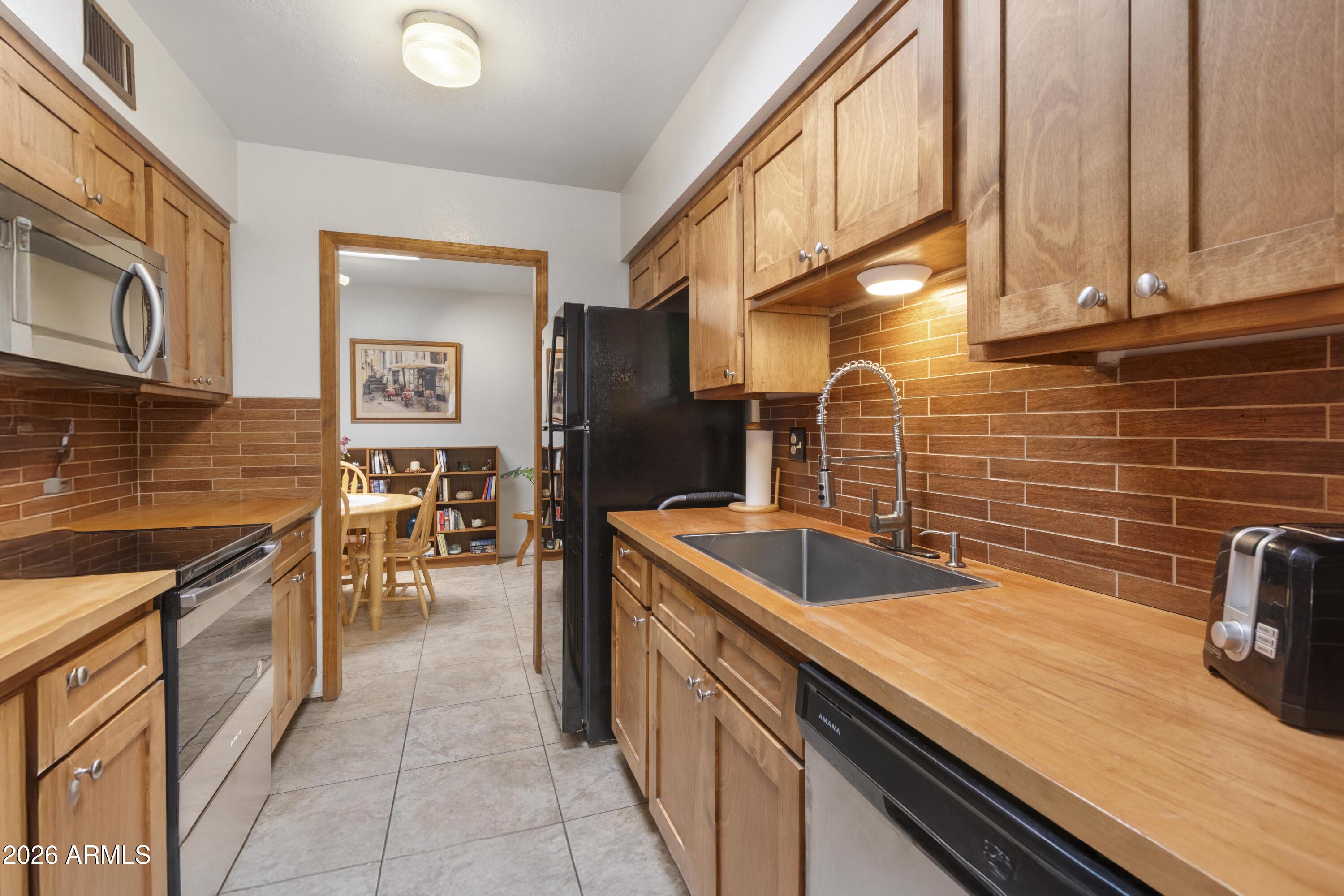9111 North Oracle Road, Unit 110 Tucson, AZ 85704 - Photo 9 of 27 a kitchen with a sink and cabinets
