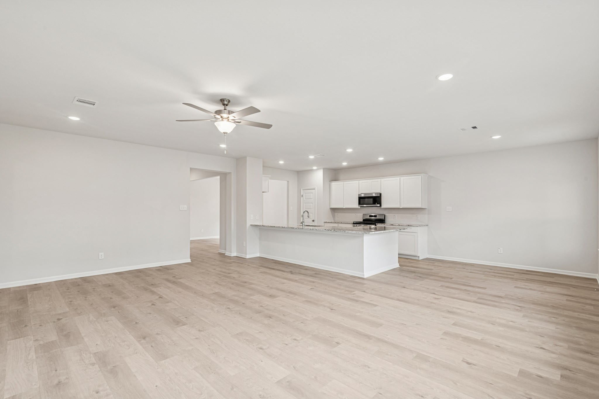 1903 Temple Grove Drive Rosharon, TX 77583 - Photo 13 of 37 The Avery- Family Room into Breakfast Area and Kitchen