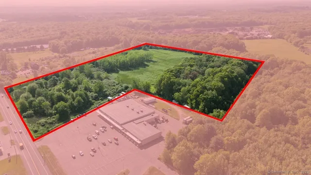 a view of a small space in front of a yard with an umbrella