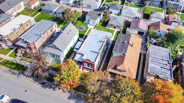 an aerial view of a city with lots of residential buildings ocean and mountain view in back