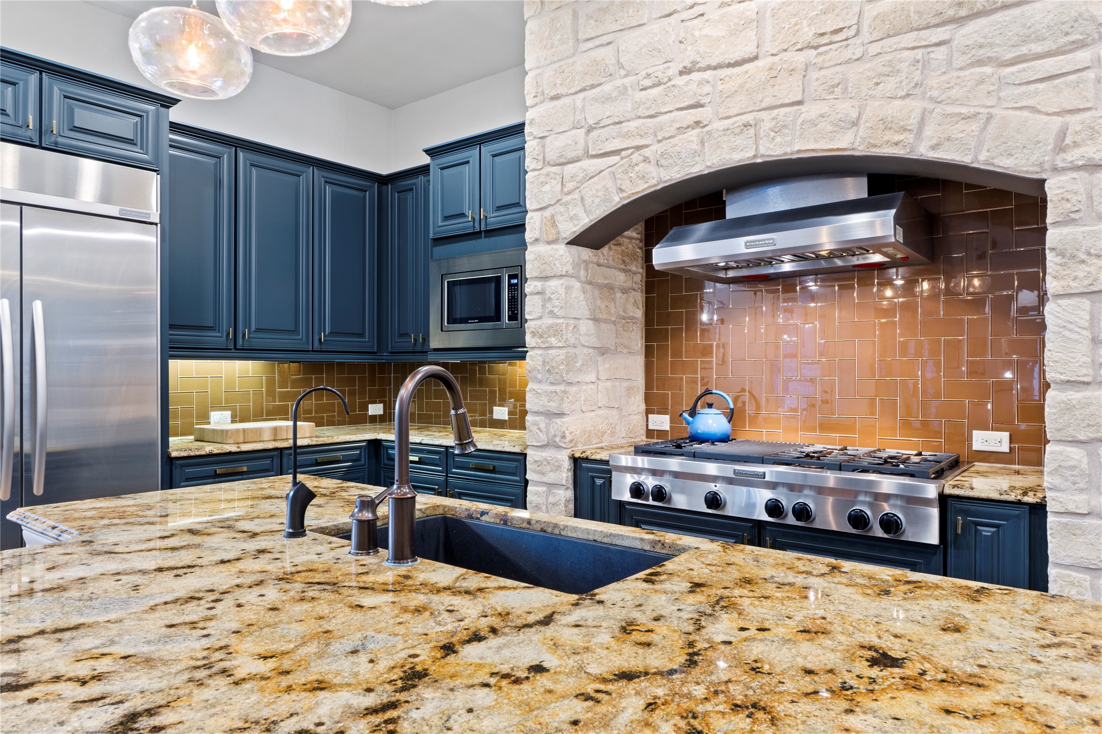 2520 Ionian Cove Austin, TX 78730 - Photo 9 of 40 a kitchen with stainless steel appliances kitchen island granite countertop a sink and cabinets