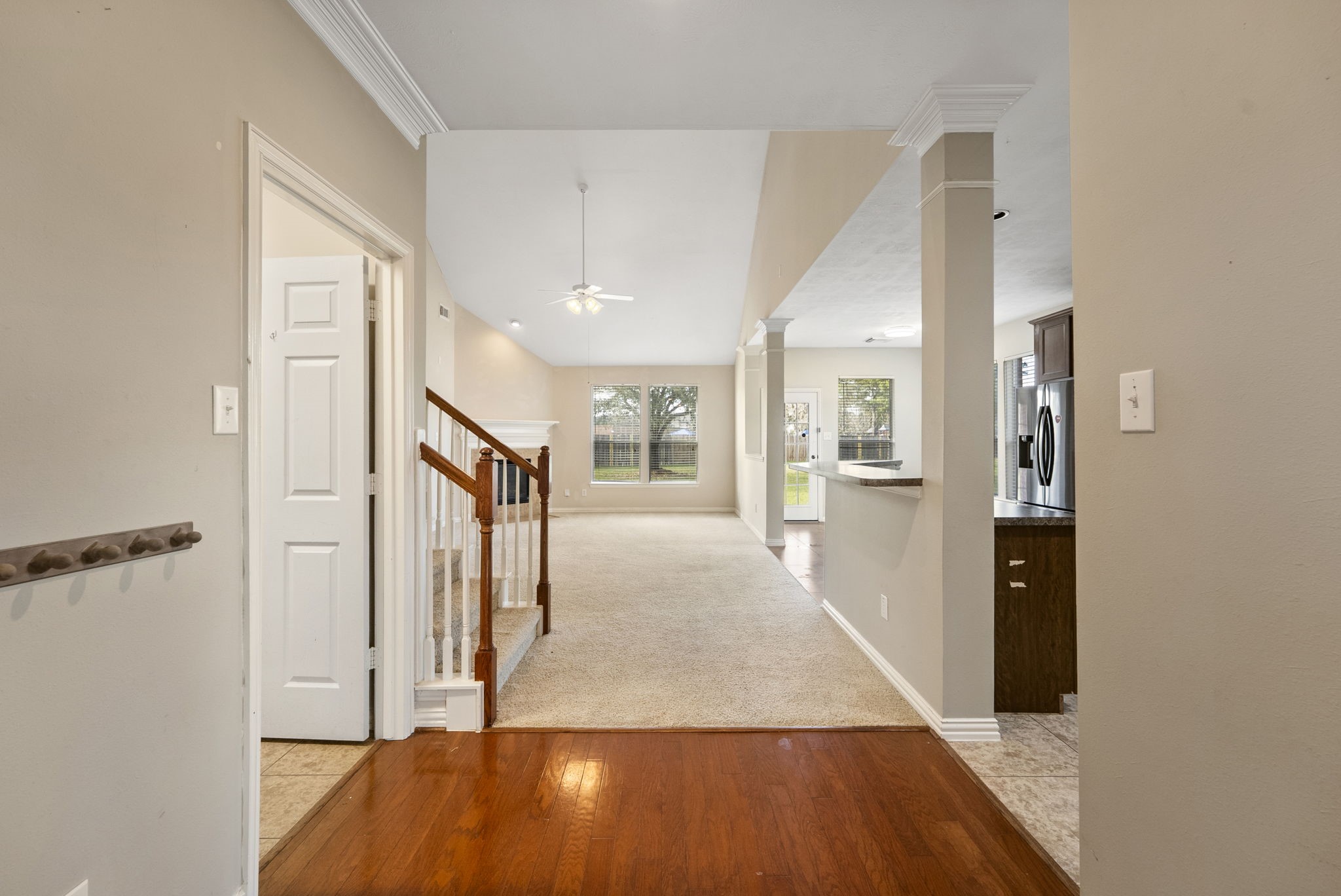 9526 Tartan Manor Street Spring, TX 77379 - Photo 11 of 42 a view of a hallway with wooden floor and a bathroom