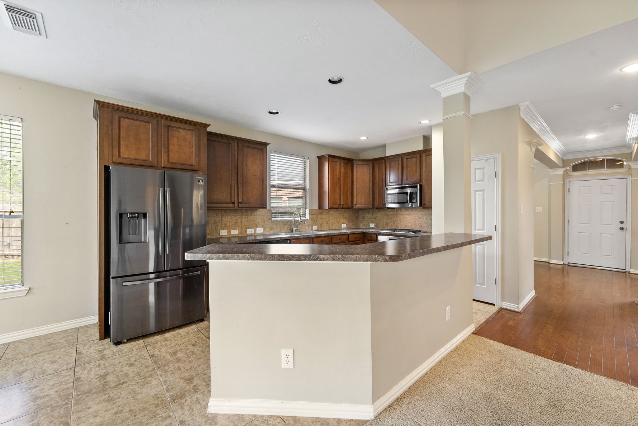 9526 Tartan Manor Street Spring, TX 77379 - Photo 15 of 42 a kitchen with stainless steel appliances granite countertop a refrigerator and a stove top oven