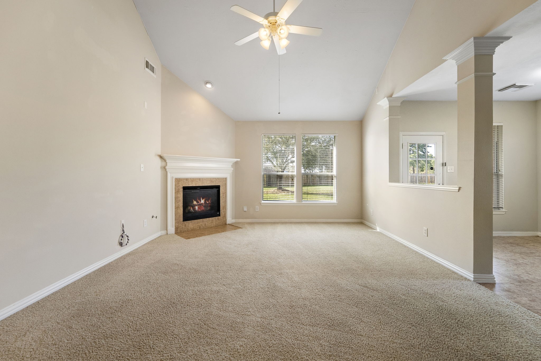 9526 Tartan Manor Street Spring, TX 77379 - Photo 20 of 42 an empty room with windows and fireplace