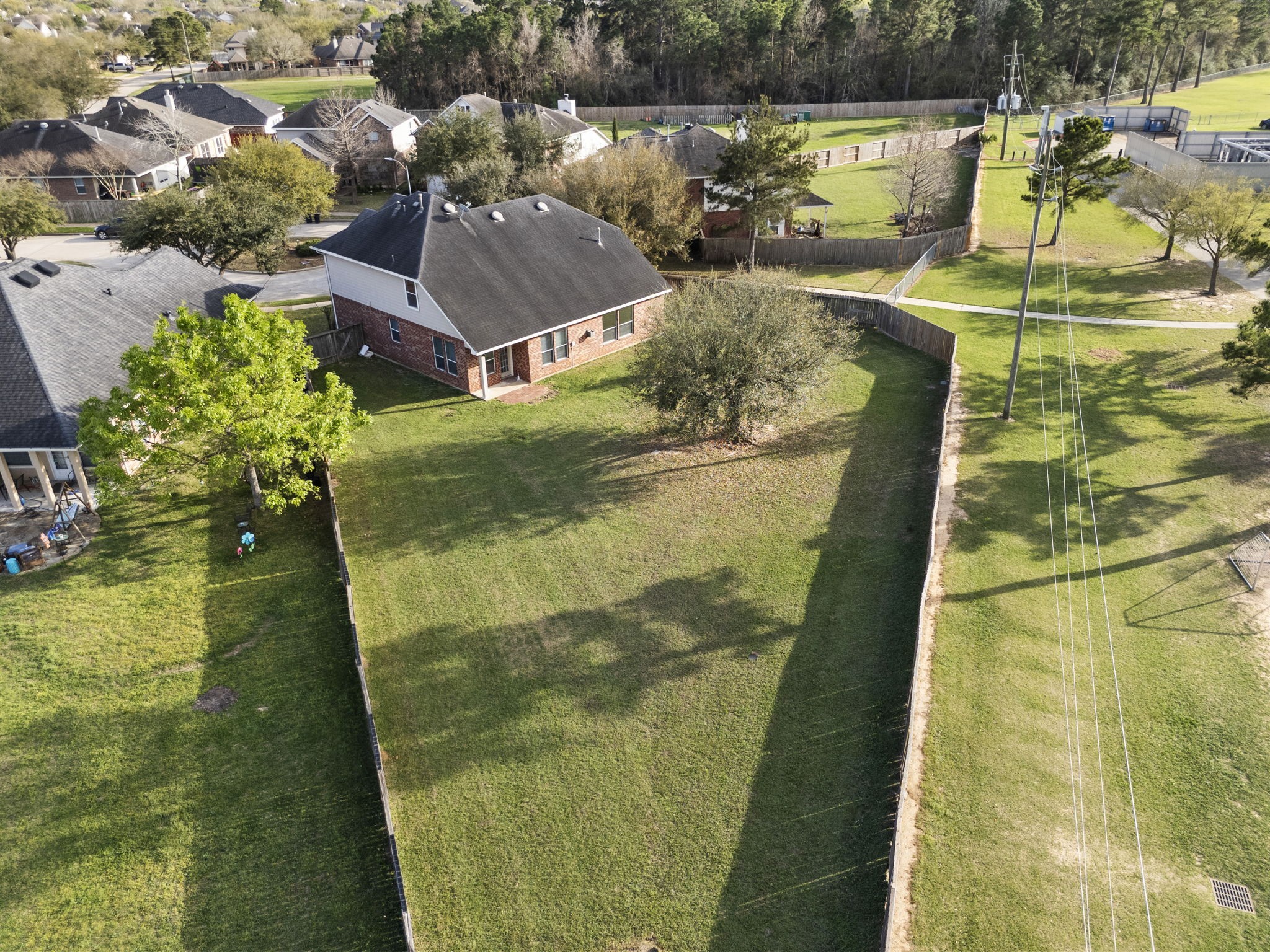 9526 Tartan Manor Street Spring, TX 77379 - Photo 2 of 42 a view of a swimming pool with a yard