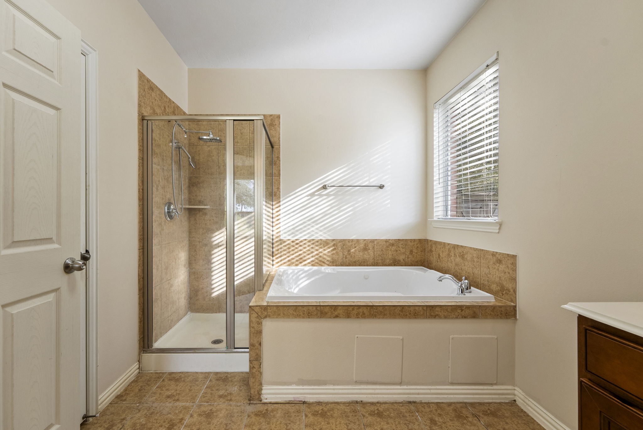 9526 Tartan Manor Street Spring, TX 77379 - Photo 27 of 42 a bathroom with a tub shower and sink