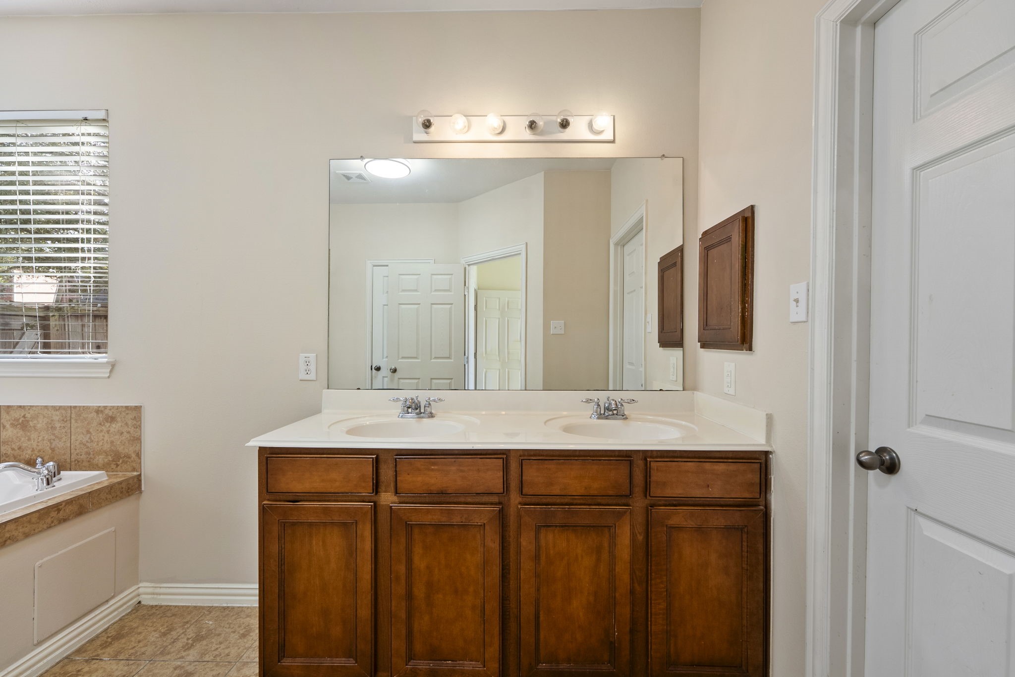 9526 Tartan Manor Street Spring, TX 77379 - Photo 28 of 42 a bathroom with a sink and a mirror