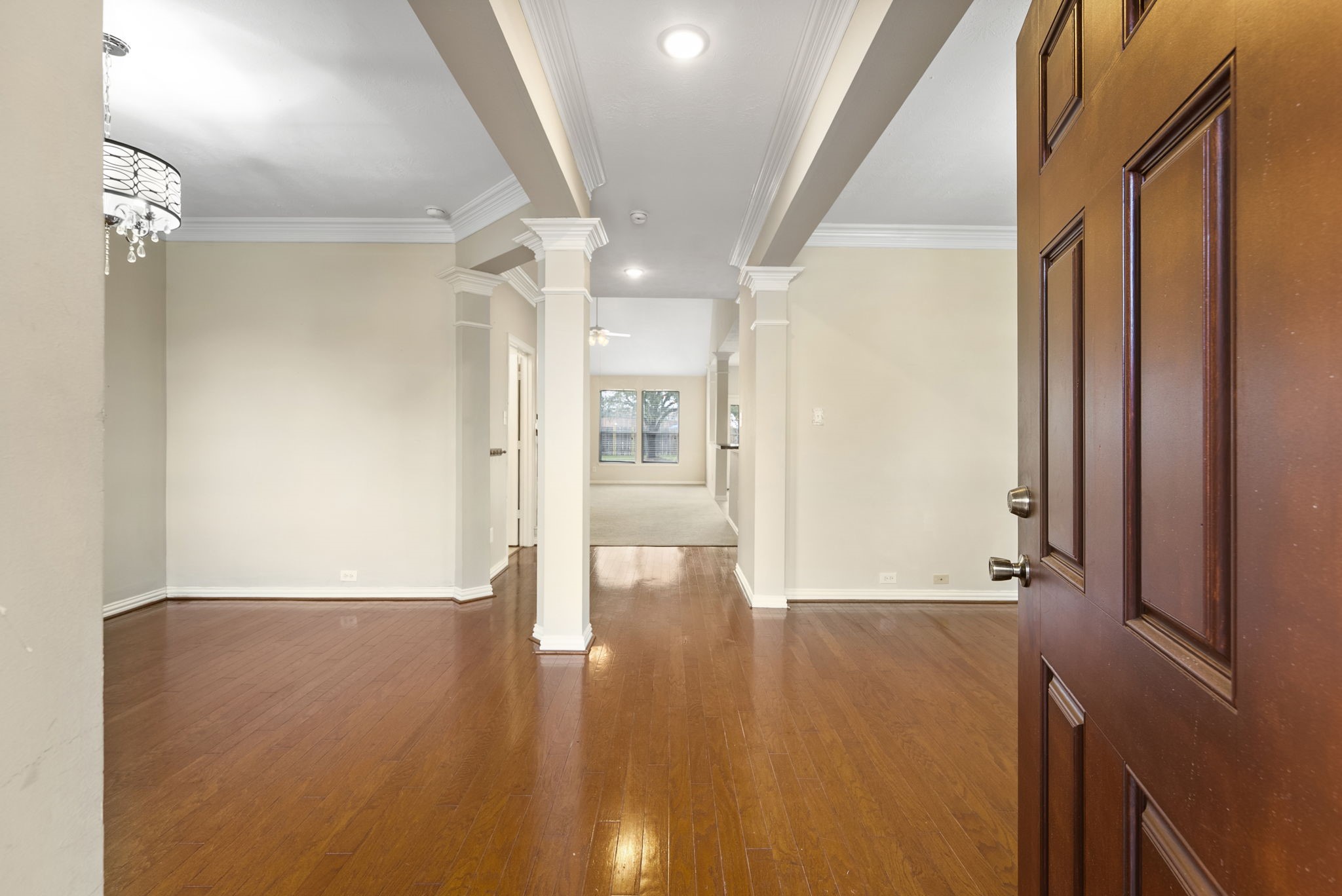 9526 Tartan Manor Street Spring, TX 77379 - Photo 6 of 42 a view of an empty room with wooden floor and a window
