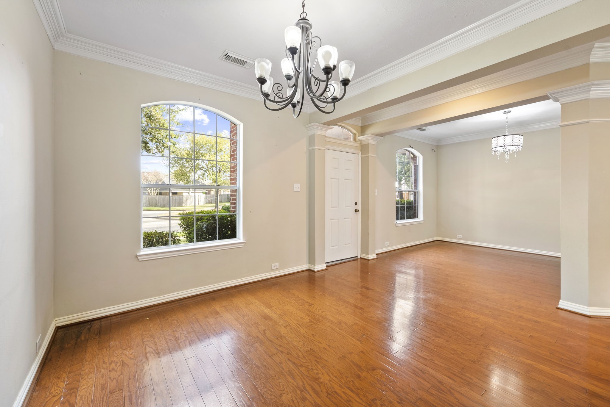 9526 Tartan Manor Street Spring, TX 77379 - Photo 10 of 42 an empty room with wooden floor chandelier and windows