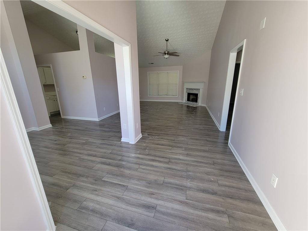 2213 Carlton Chase Road Dacula, GA 30019 - Photo 5 of 30 a view of a hallway with wooden floor and staircase