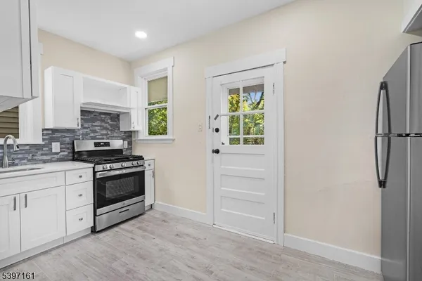 a kitchen with granite countertop a stove and a sink