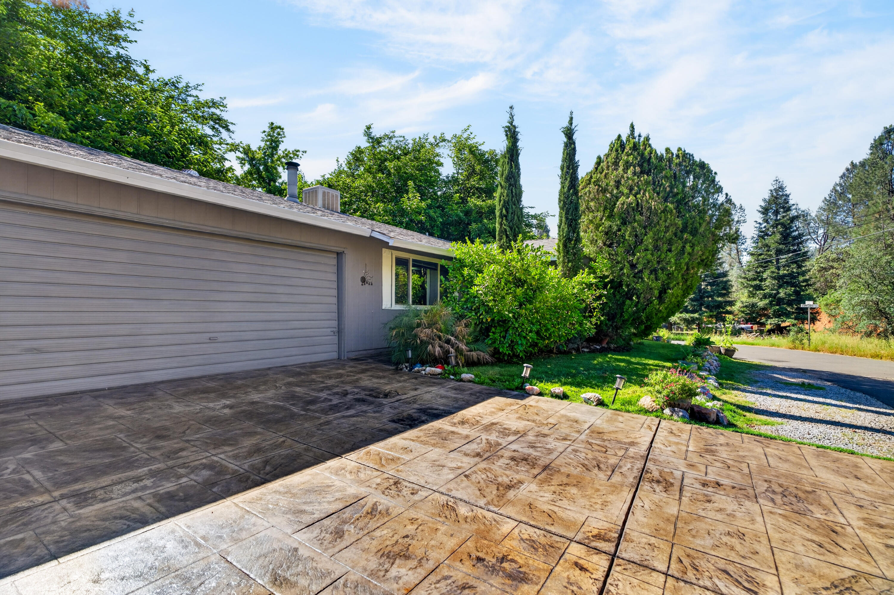 1391 Rouge Road Shasta Lake, CA 96019 - Photo 3 of 30 a view of a backyard with potted plants and large tree