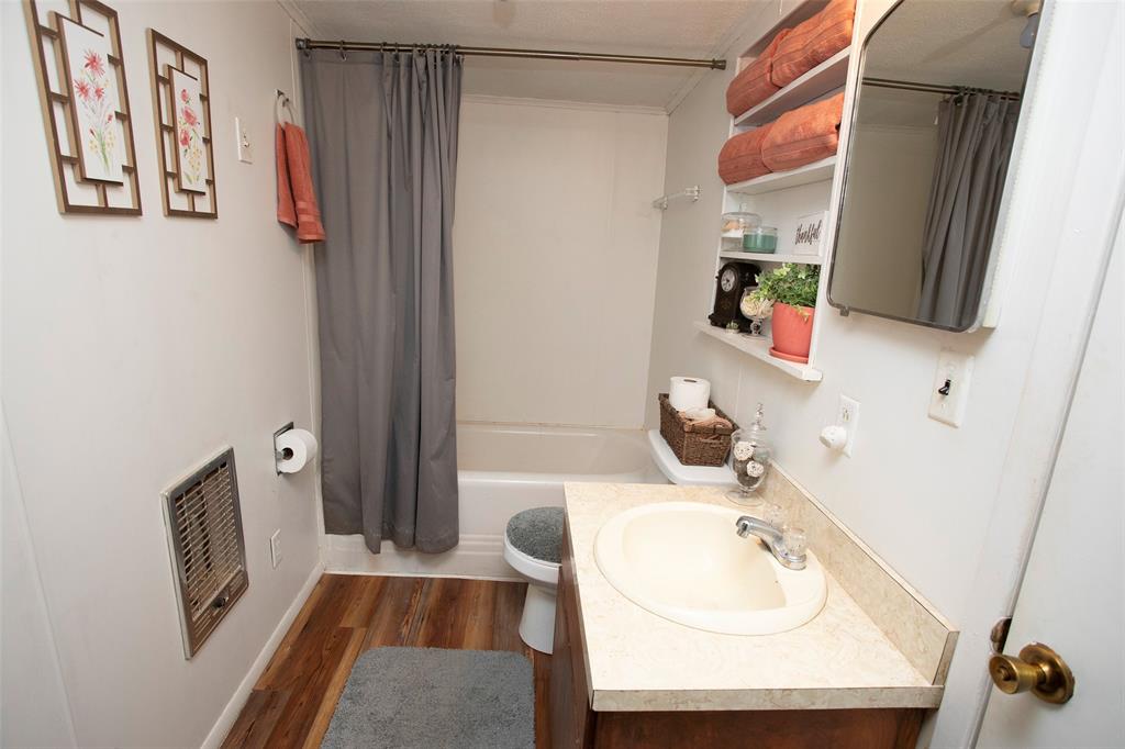 9051 Lacy Road Graford, TX 76449 - Photo 16 of 23 a bathroom with a sink toilet and shower