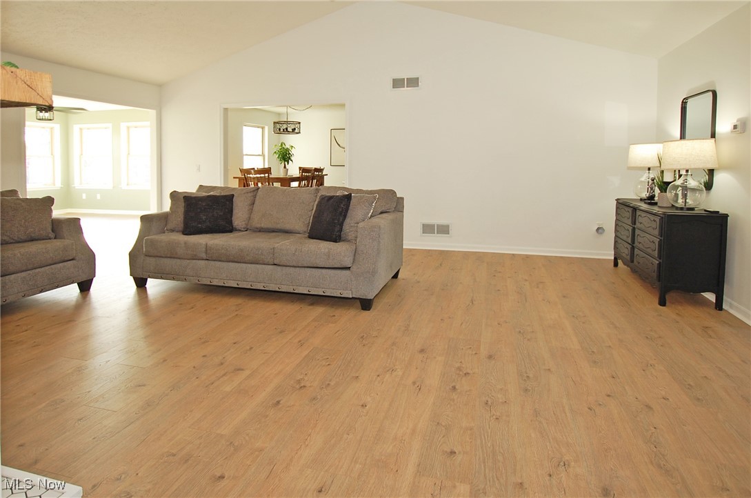 26875 W Road Wellington, OH 44090 - Photo 10 of 26 Living room with light hardwood / wood-style floors and lofted ceiling