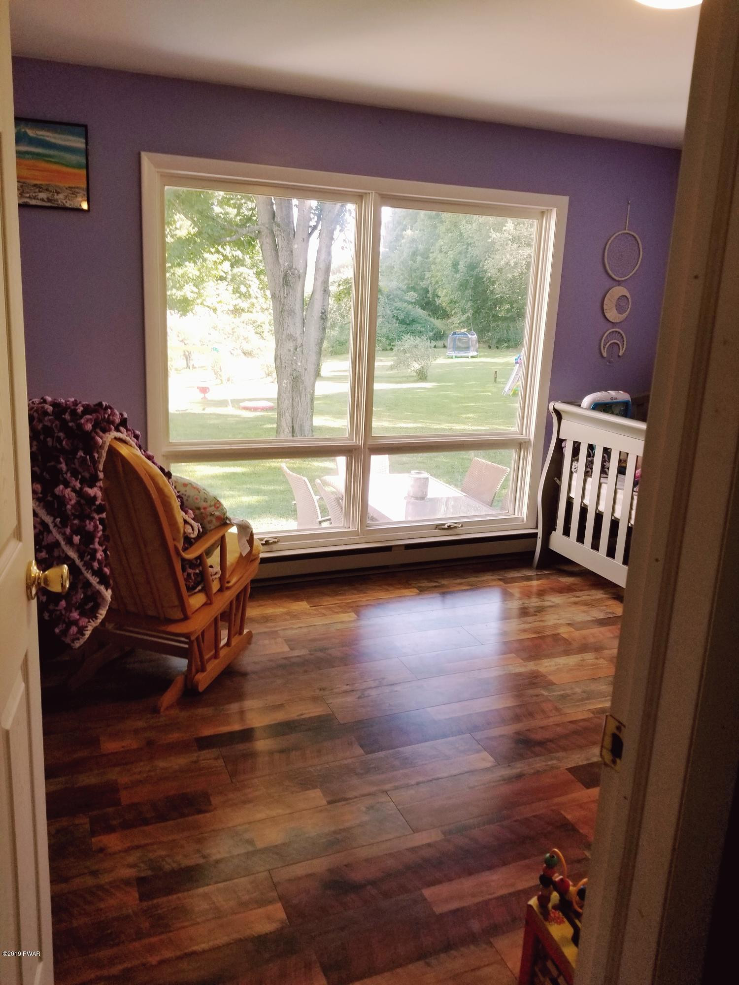 144 Mid Valley Road Lake Ariel, PA 18436 - Photo 35 of 55 a living room with furniture and a large window