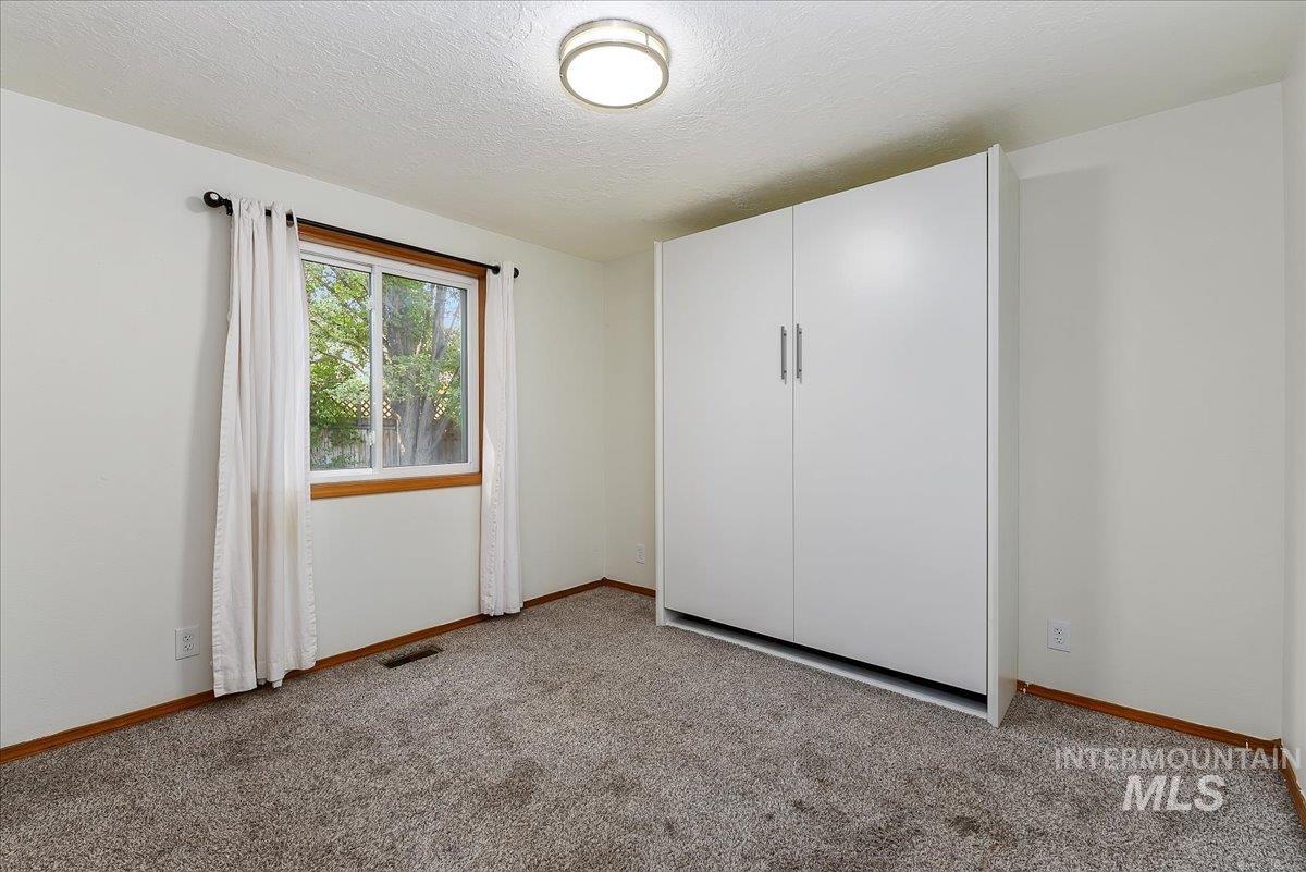 9215 West Preece Street Boise, ID 83704 - Photo 11 of 22 Built-in wall bed system featuring white cabinetry and brushed nickel hardware