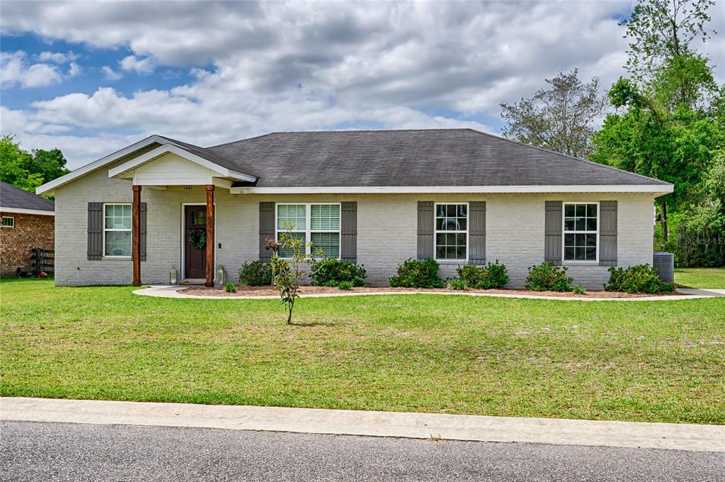2032 Southwest 252nd Street Newberry, FL 32669 - Photo 1 of 1 a front view of a house with a yard and garage