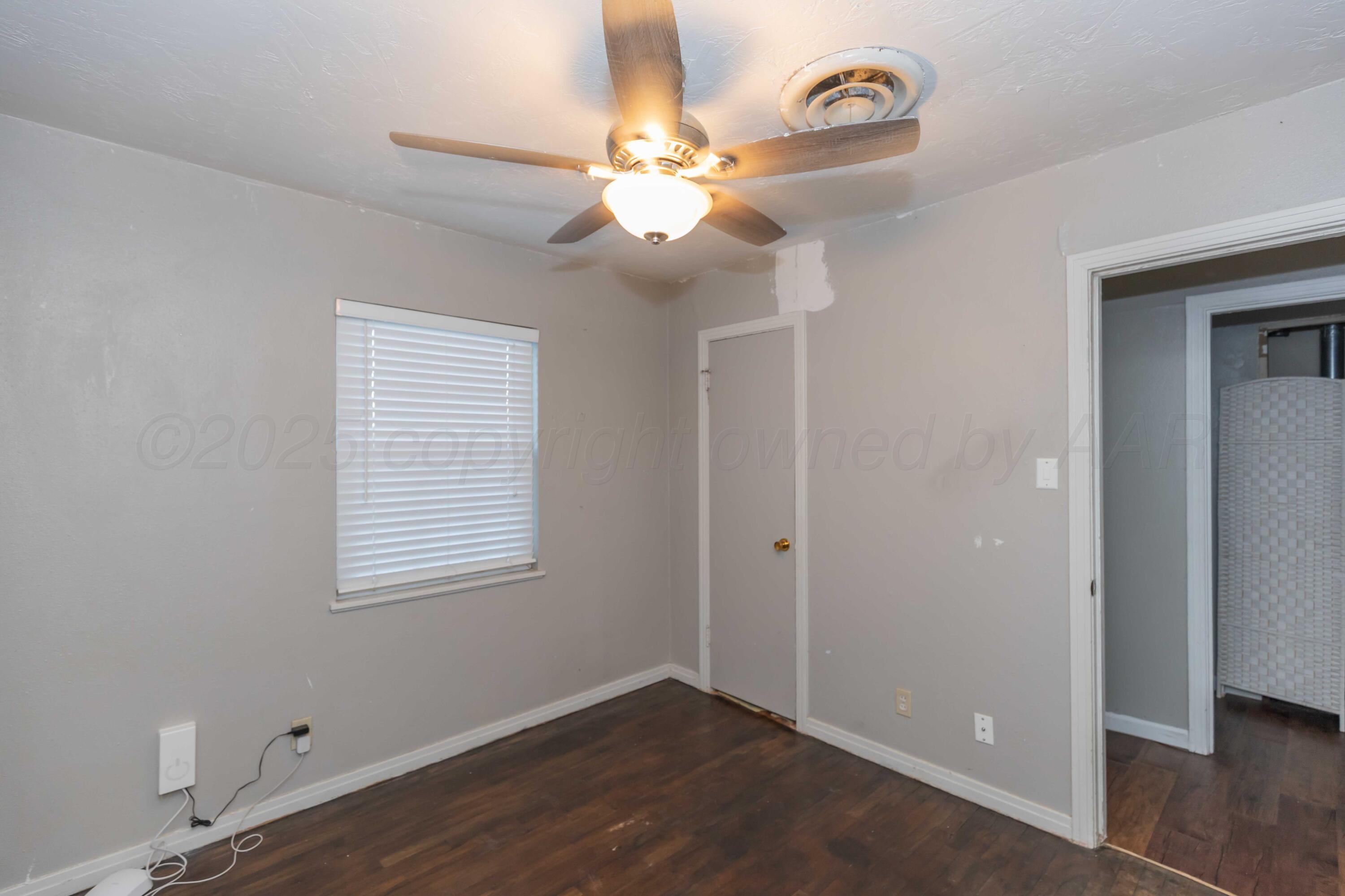 4516 South Bonham Street Amarillo, TX 79110 - Photo 21 of 30 a view of an empty room with wooden floor and a window