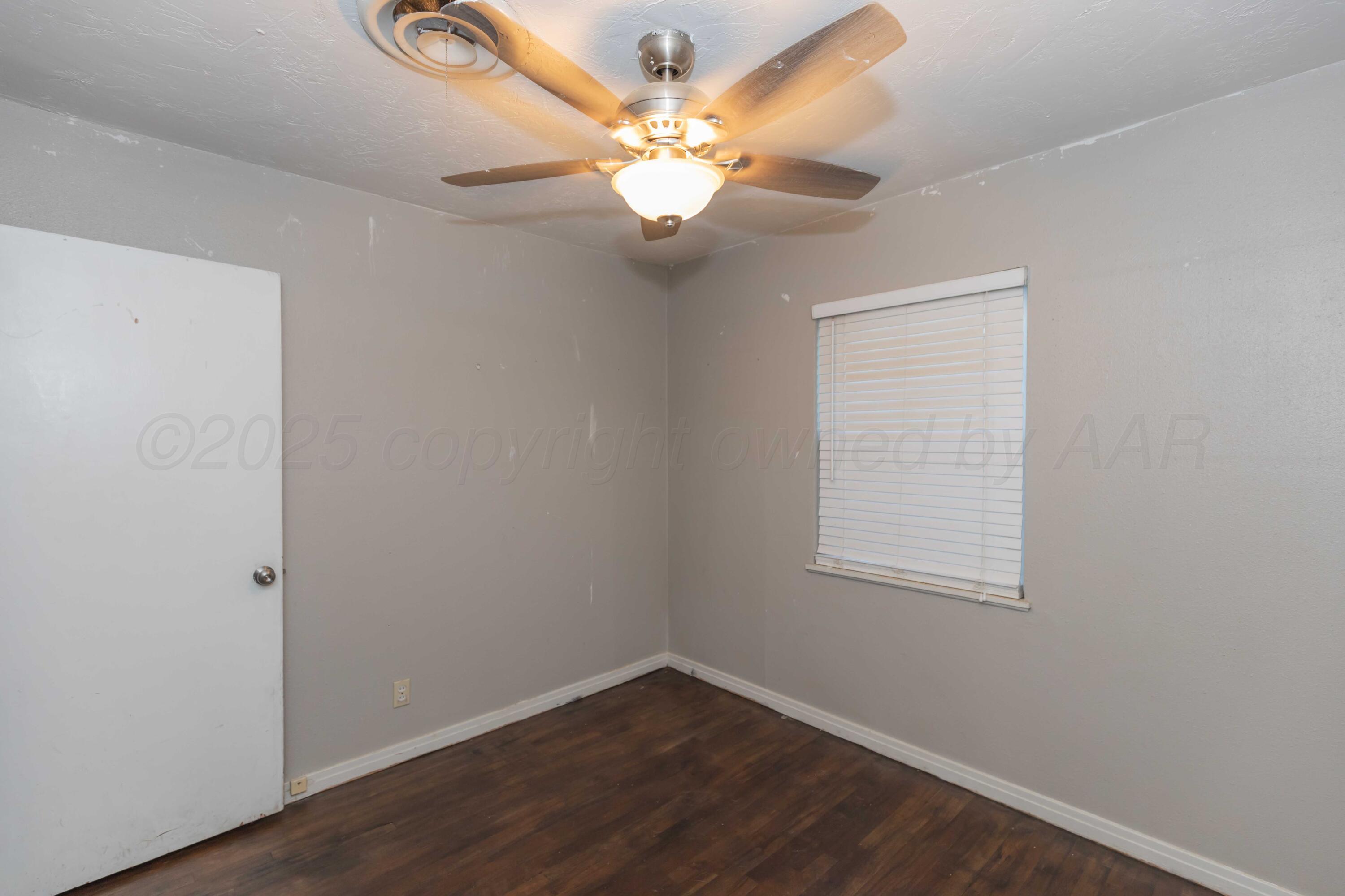 4516 South Bonham Street Amarillo, TX 79110 - Photo 23 of 30 an empty room with a window and a chandelier fan