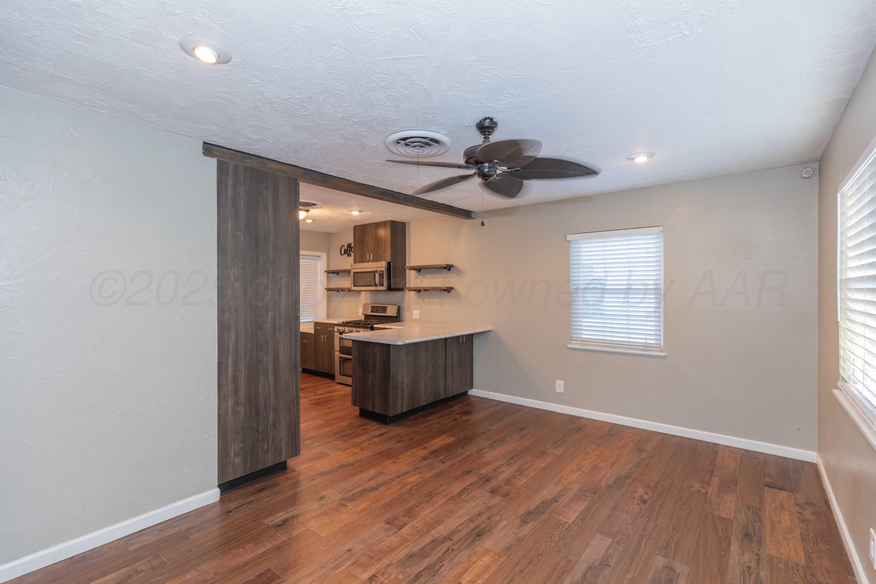 4516 South Bonham Street Amarillo, TX 79110 - Photo 4 of 30 a view of kitchen with stainless steel appliances wooden floor and window