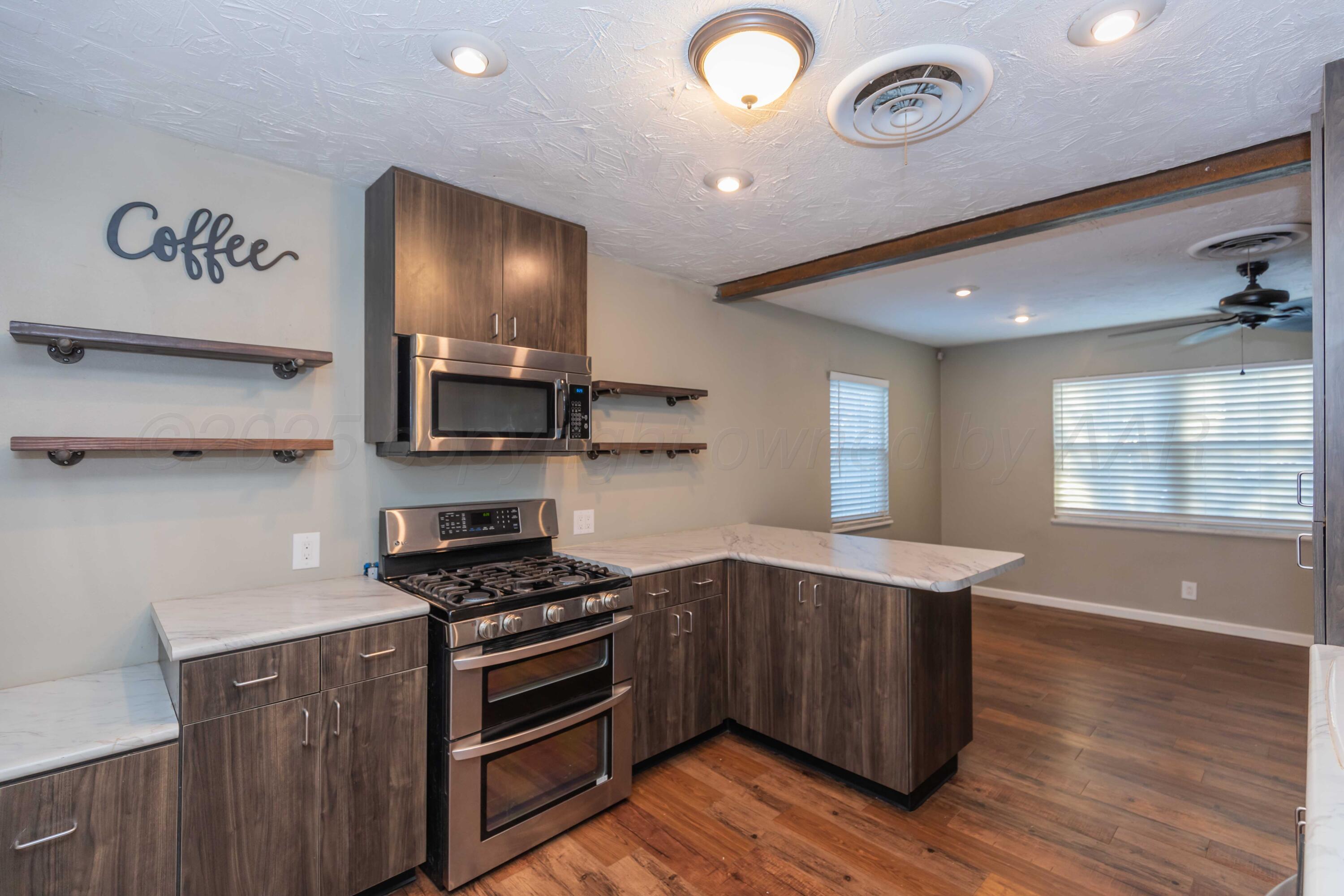4516 South Bonham Street Amarillo, TX 79110 - Photo 10 of 30 a kitchen with stainless steel appliances granite countertop a stove and a sink