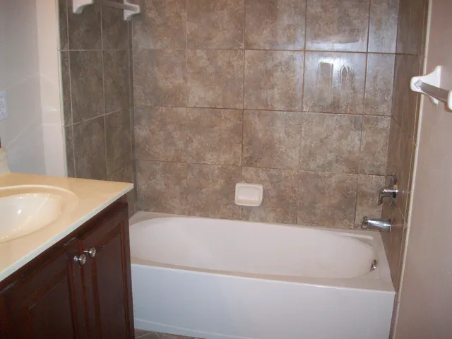a bath tub sitting next to a white sink