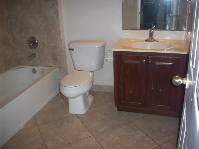 a bathroom with a sink a toilet and bathtub