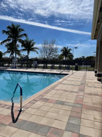 a swimming pool with trees in front of it