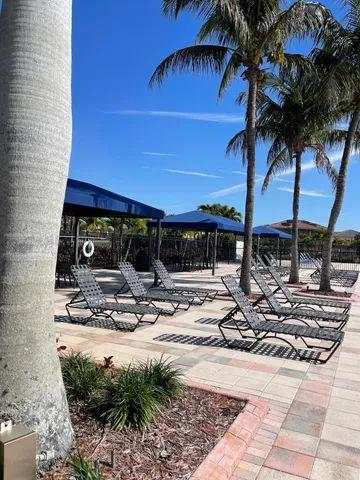 a view of the house with swimming pool and porch