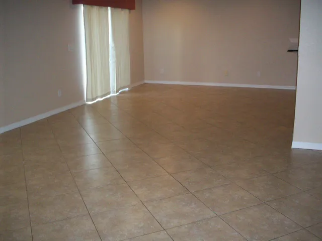 a view of a room with an empty space and a window