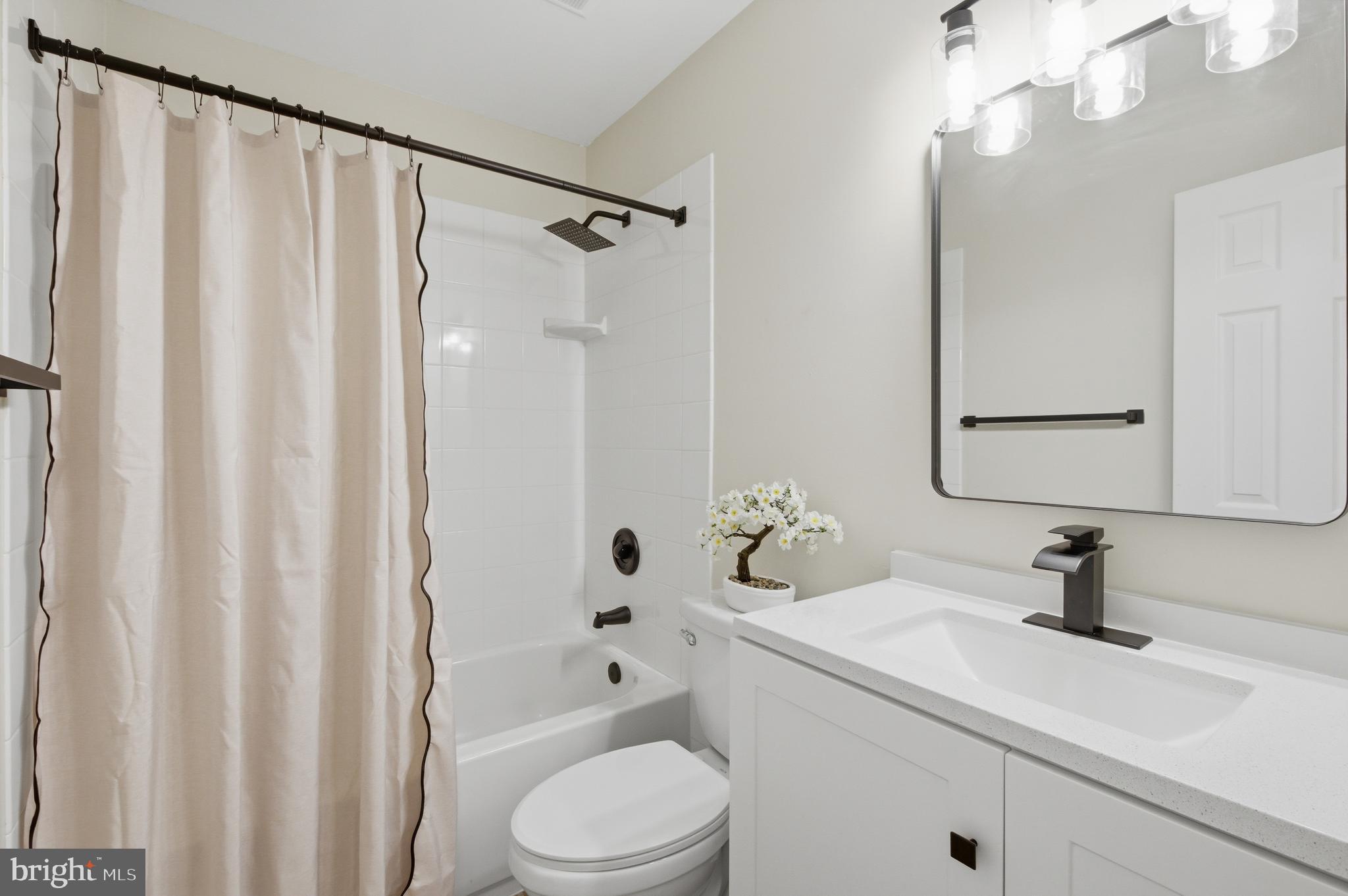 8575 Tyrolean Way Springfield, VA 22153 - Photo 21 of 29 a bathroom with a sink a toilet and shower