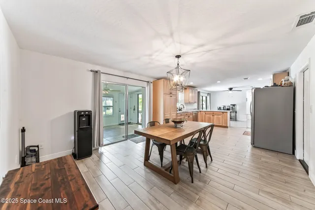 a large kitchen with a table and chairs