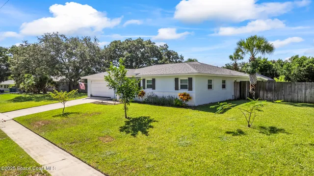 a view of a swimming pool with a patio and a yard