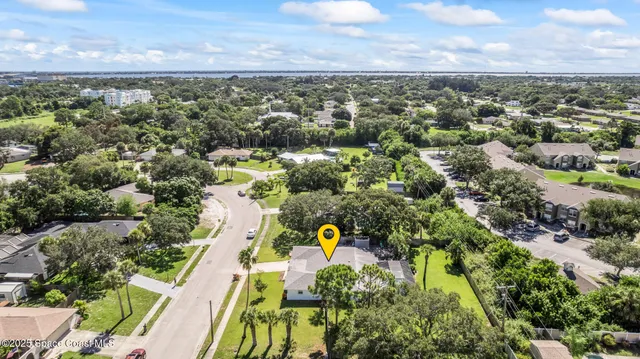 an aerial view of a houses with a yard