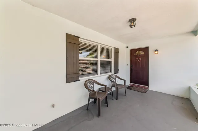 a view of a livingroom with chair and a window