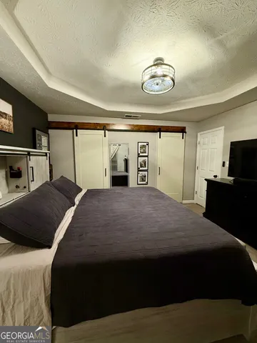 a bedroom with a bed and a chandelier