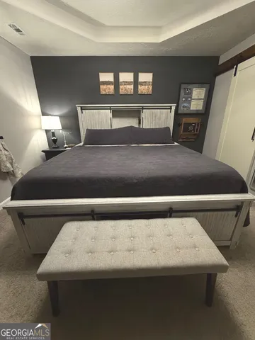 a bedroom with a bed and window