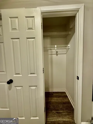 a view of a livingroom with wooden floor and staircase